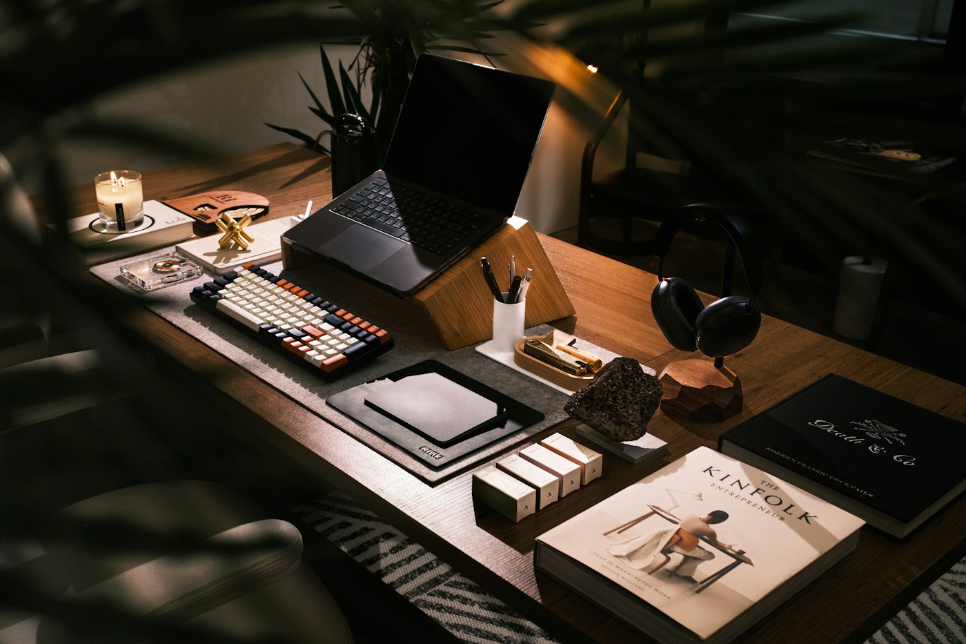 Sunlight falling across a Mac laptop on a dark wooden desk